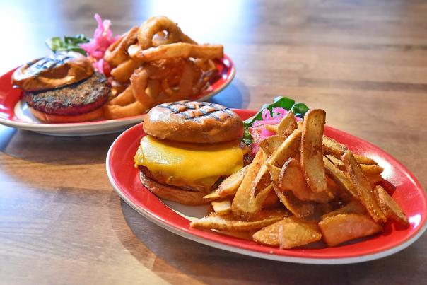 Two plates with burgers and fries