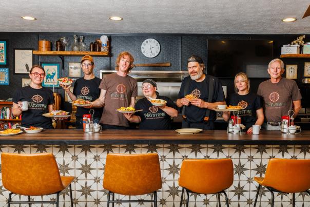 Workers behind restaurant counter
