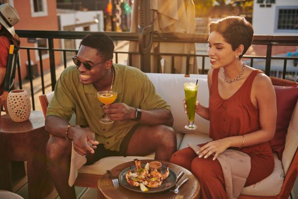 Man and woman sitting and drinking cocktails in Los Cabos