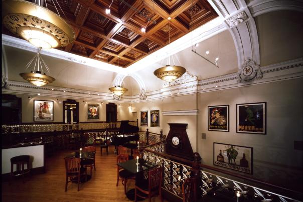 Ornate coffered wood ceiling and vintage posters inside Lightfoot Restaurant in historic downtown Leesburg, Virginia