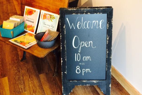 Mackinac Island shop welcome sign with store hours opening and closing times