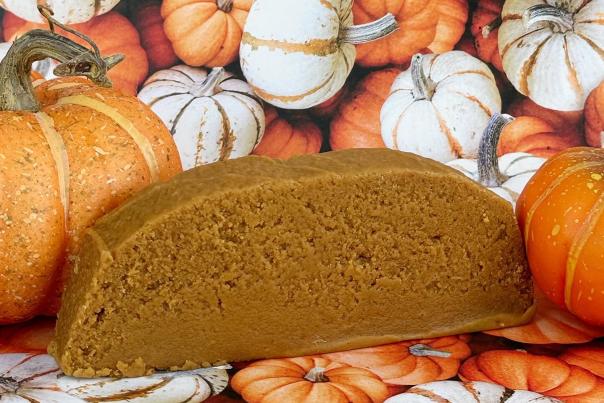 A slice of creamy, Mackinac Island fudge sits among a collection of pumpkins