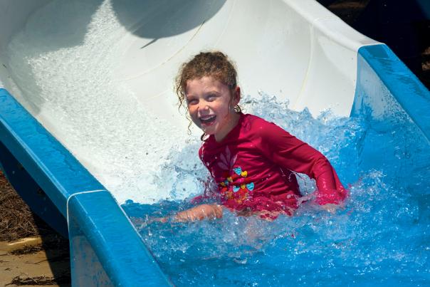 Kid on Water Slide at Sandy Beach Water Park