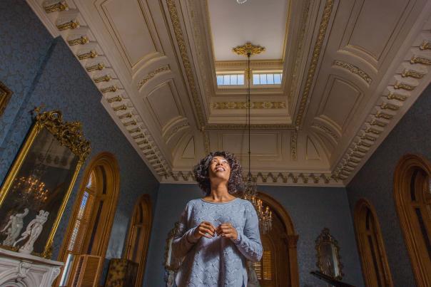A woman looks at the details on the ceiling inside of the Hay House in Macon, GA