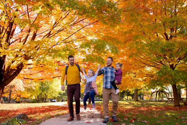 A family of two dads and their daughters walking through Aldo Leopold Nature Center.