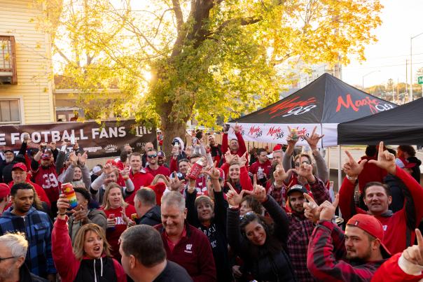 Badger sports fans cheering outside on a sportscursion