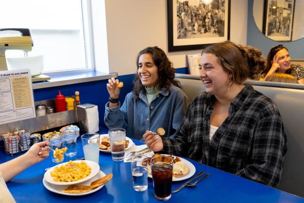 Three young women sitting at a table and enjoying their brunch at Monty's Blue Plate Diner.