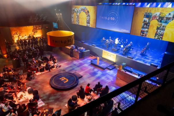 A view from the balcony at The Sylvee overlooking the stage, lounge seating and crowd at the Destination Madison 50th Anniversary party