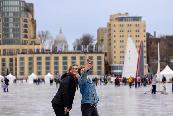 Two people out on the frozen lake taking a selfie during the Frozen Assets Festival on Lake Medonta.