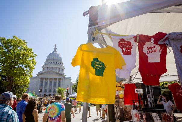 A booth at the Farmers' Market with the State Capitol behind it