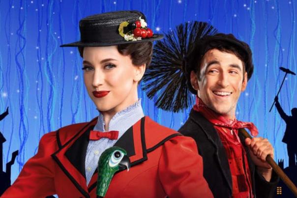two performers in front of skyline background
