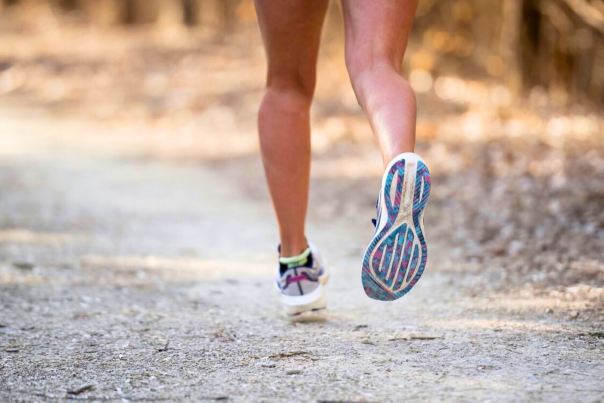 Close up on legs running on gravel path
