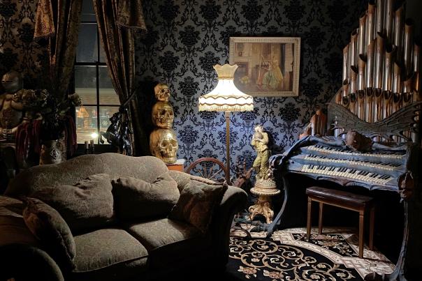 Living room couch and piano at Dead by Dawn's Dead and Breakfast