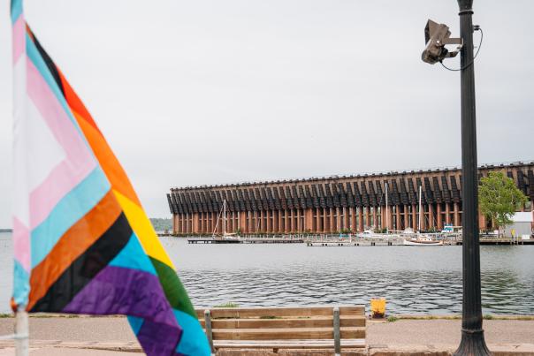 A pride flag in front of the historic Lower Harbor Ore Dock in Marquette, MI