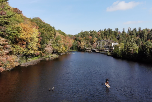 Stand up paddle boarding on the Dead River in autumn