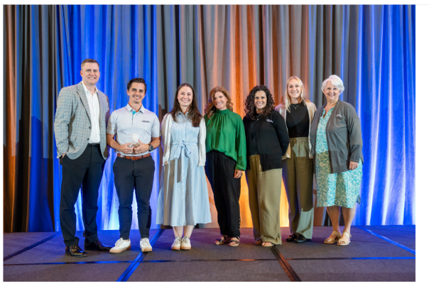 Six team members of Visit McKinney accepting two awards from Destinations Texas.