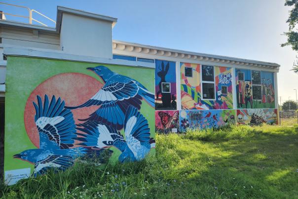 walls covered in colorful murals at MillHouse McKinney in the Cotton Mill