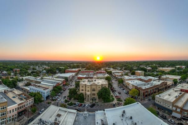 Yellow sun setting over the skyline in Downtown McKinney