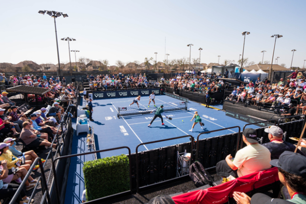 Pickleball players hitting the ball back and forth in a competition on a pickleball court