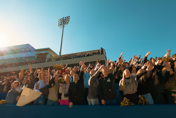 Fans at a football stadium cheering