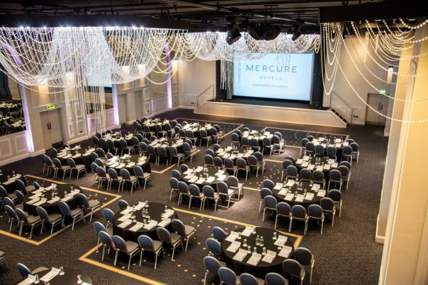 Conference room set up with round tables theatre style