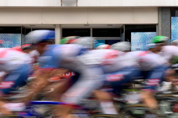 Cyclists riding past the camera in a blur