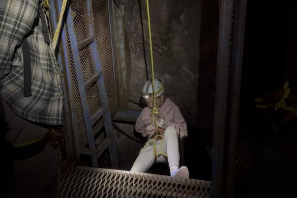 A young girl repelling at Adventure Mining Company in the Upper Peninsula of Michigan