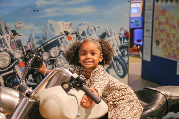 Girl smiling on a Harley-Davidson Motorcylce