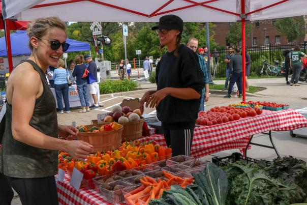 Woman buying fresh produce from a Farmers Market vendor