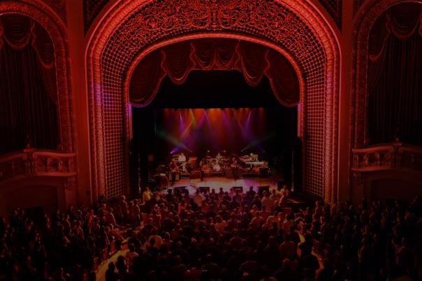 an image of the pabst theater stage mid-concert with a red overlay