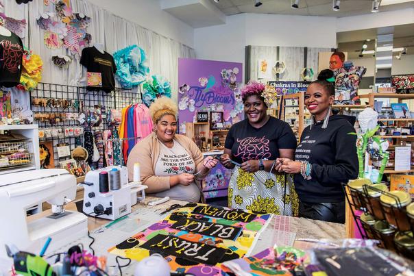 three women smiling in a store