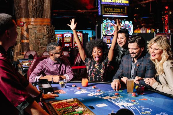 players gathered around table game while one cheers