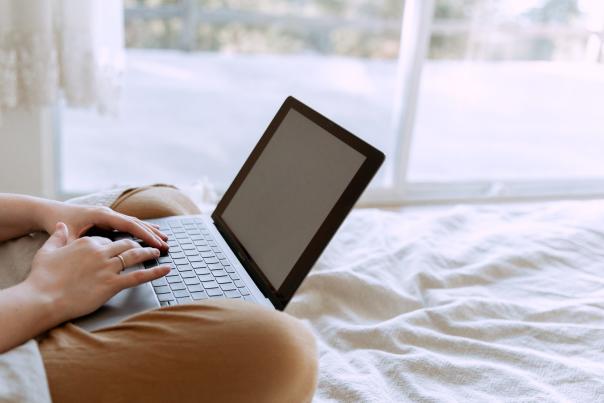 side-view-of-unrecognizable-freelancer-working-on-laptop-on-3975582