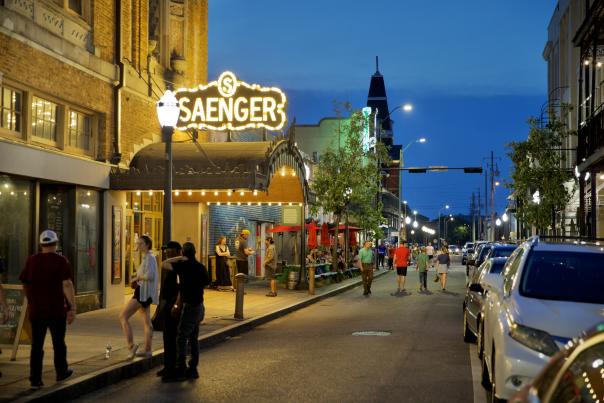 night time street view of the Saenger theatre with lighted, covered entrance