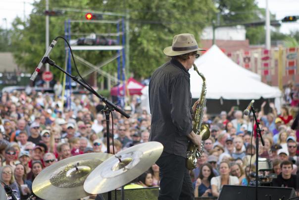 saxophone player on stage in front of a crowd