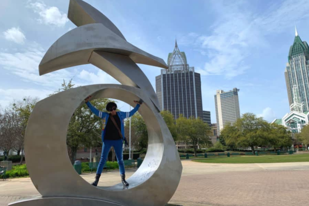 sculpture in mobile alabama with person standing in the center