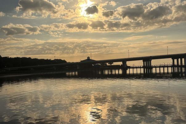 A bridge crossed the water at sunset