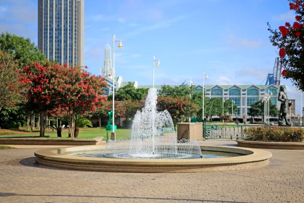 park with water fountain in the middle and Convention Center in the background
