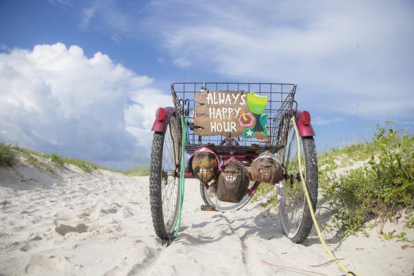 Old, three wheel bicycle parked on the beach