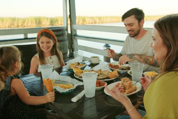 family of four eating an al fresco meal