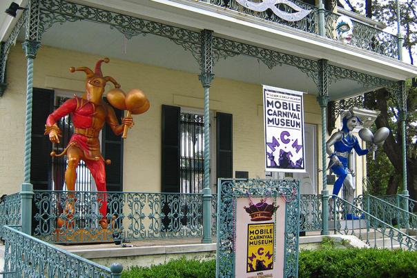 building with two jester statues on the porch