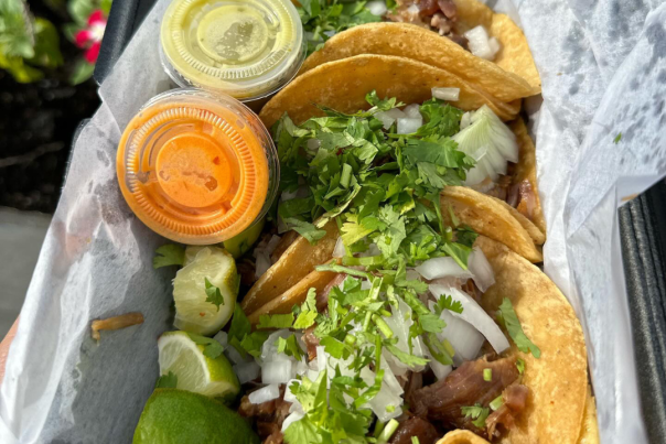 tray of tacos and sauces
