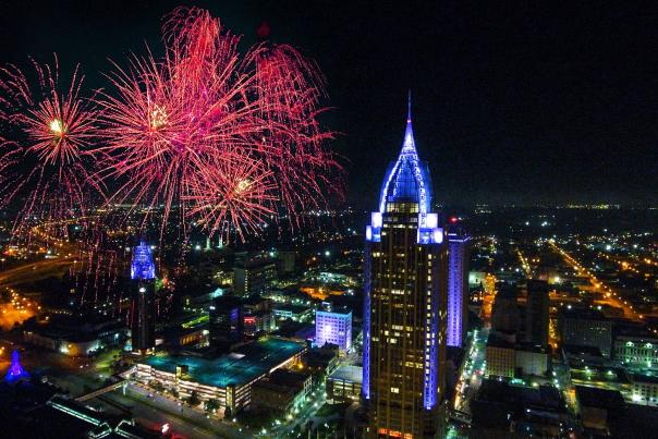 Downtown Mobile at night with fireworks in the sky