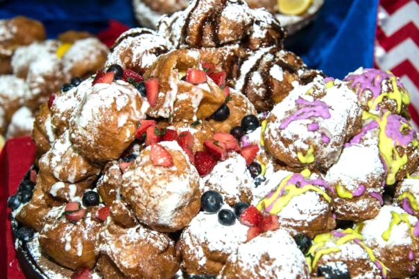 beignets with blueberries, strawberries, powdered sugar and icing