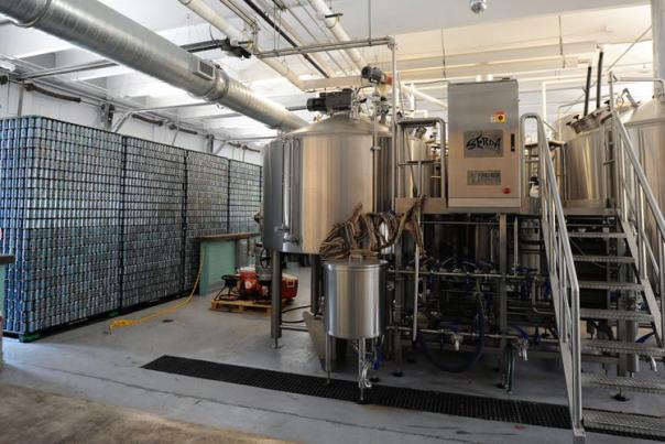 inside a brewery showing large steel appliances