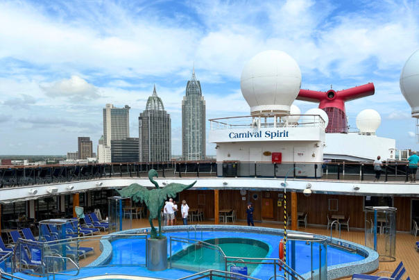 View of top deck of the Carnival Spirit ship. Pool, jacuzzi and reclining deck chairs
