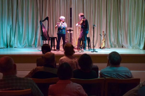 two people on stage playing music