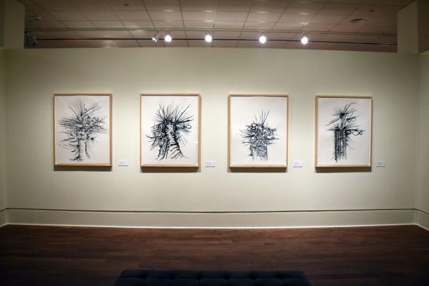 row of hanging black and white art at a museum