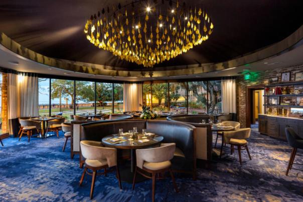 Banquet room with chandelier and tables with booths and chairs