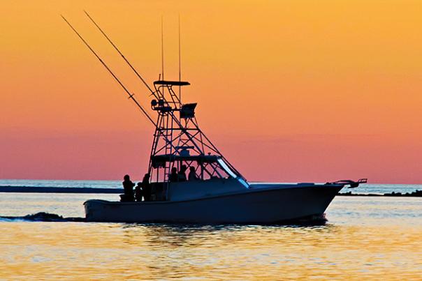 a boat on the water in mobile alabama at sunset
